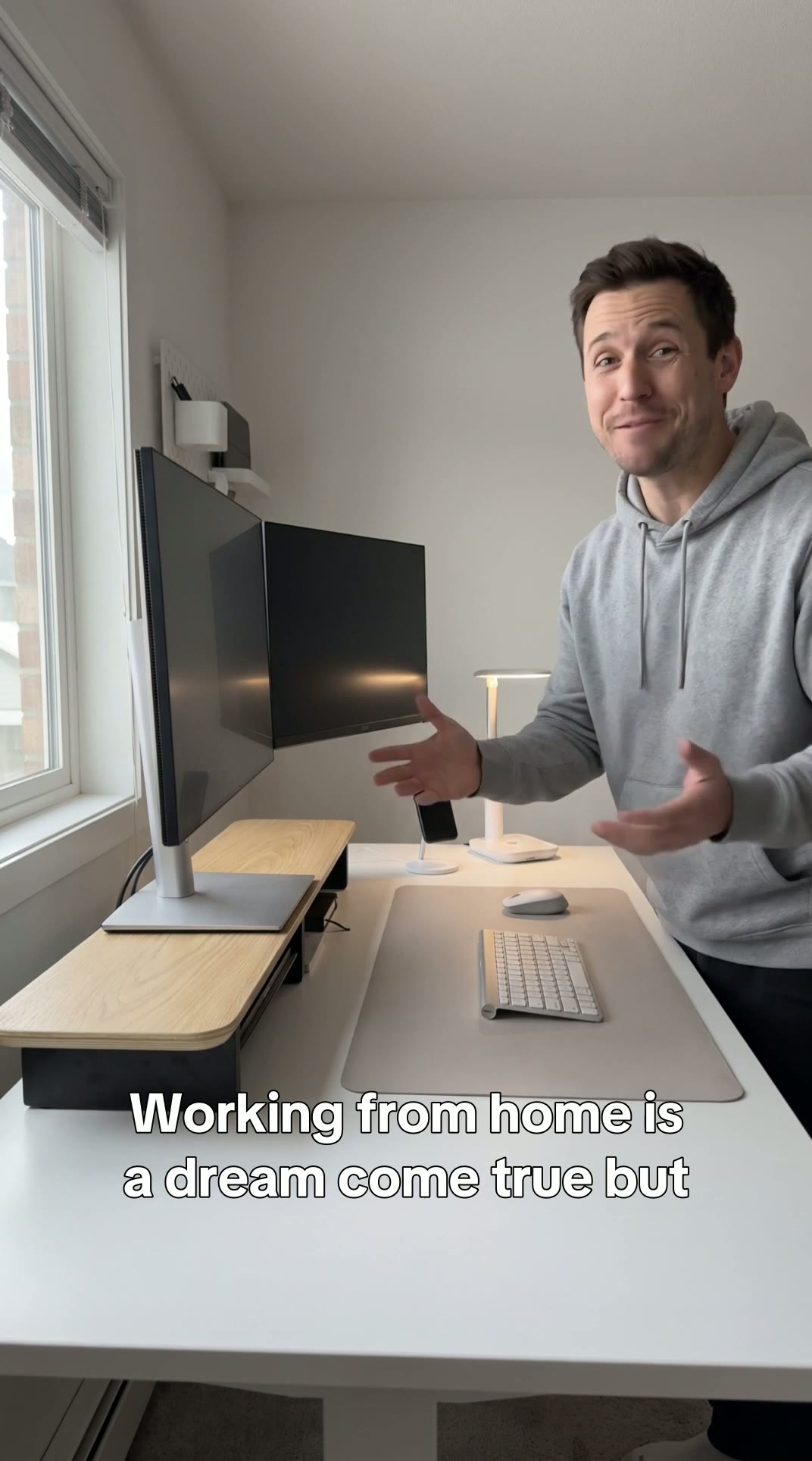 Dual monitor riser holding two screens at eye level on a tidy home office desk